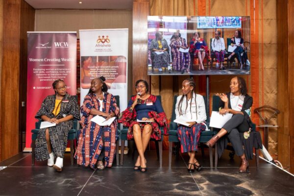 A panelist (with mic) during The Graça Machel Trust Women Creating Wealth Programme graduation held at the Capital Club East Africa sharing my Investor Readiness coaching experience for a concluded cohort.